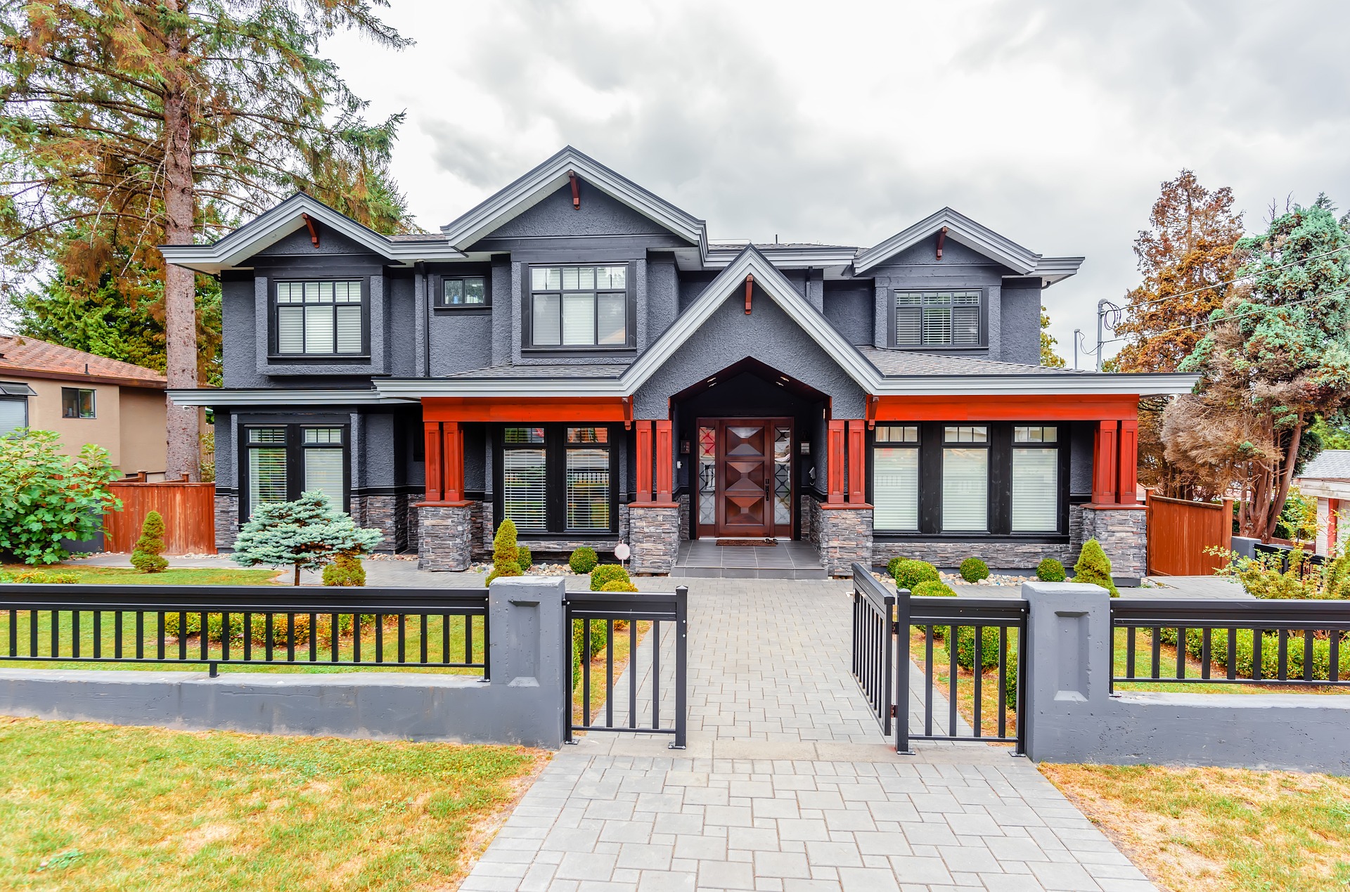 beautiful exterior of modern home with gray and orange details