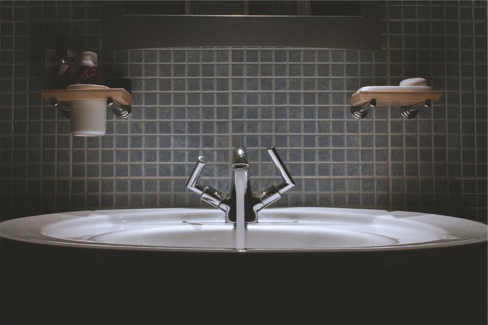 bathroom sink with blue backsplash