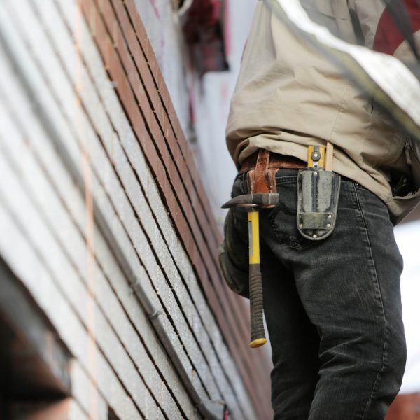 Close-up view of construction worker's tool belt as he works outside