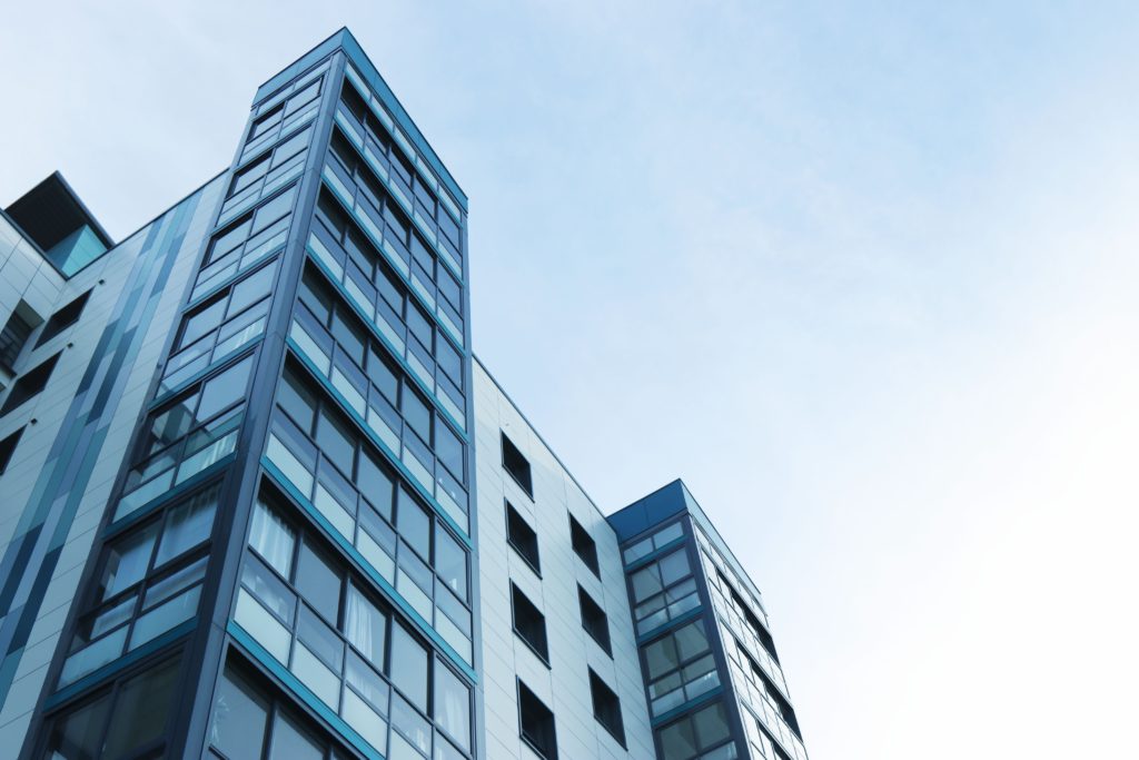 Looking up at windows of modern office exterior