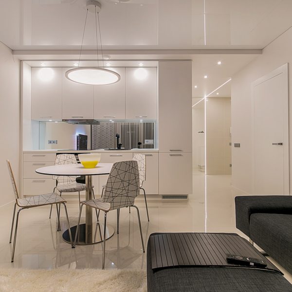 Modern white and gray apartment kitchen and living room