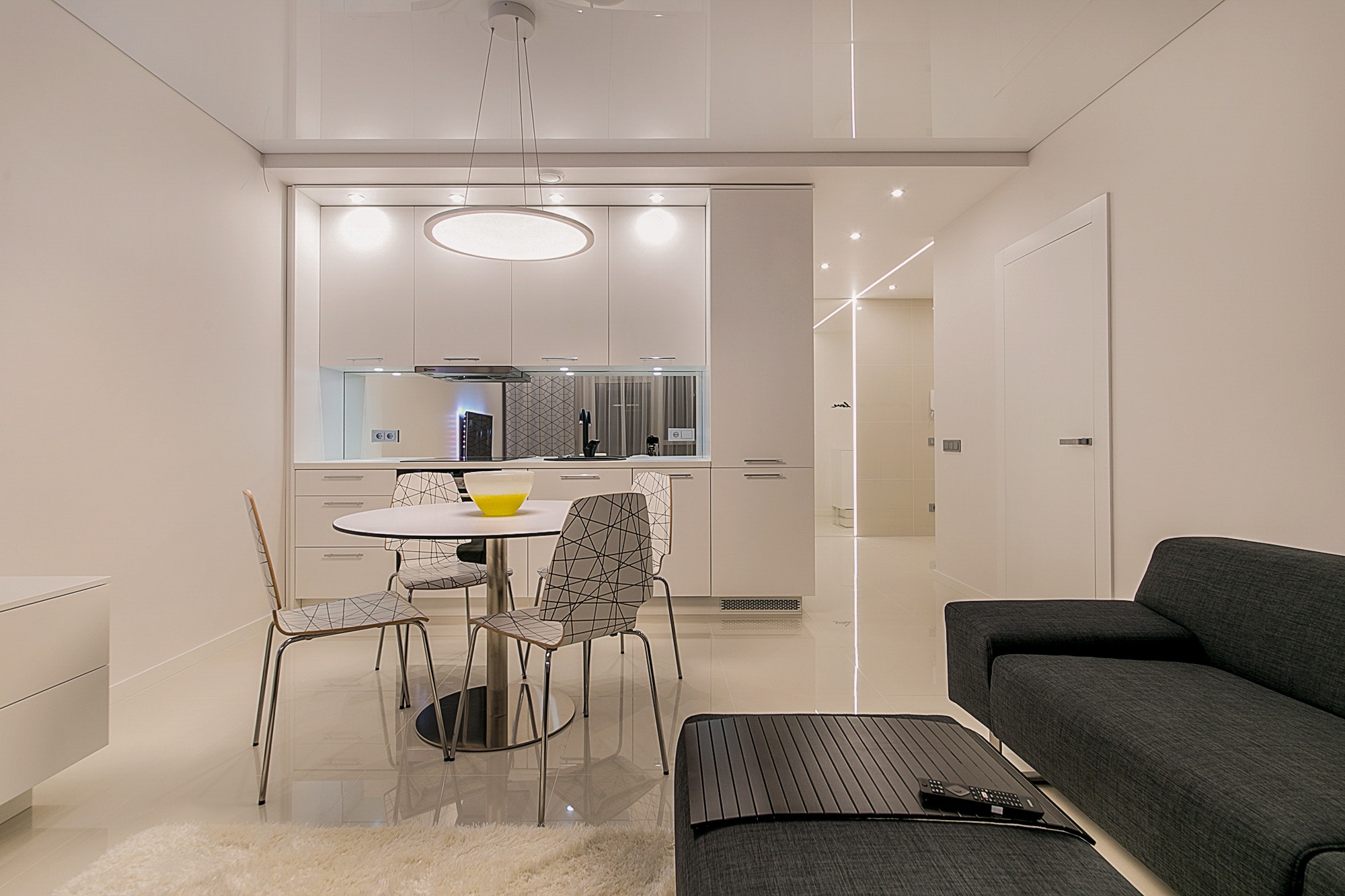 Modern white and gray apartment kitchen and living room