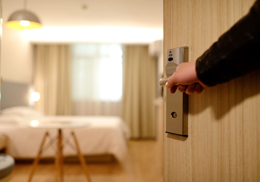 Hand opening hotel room door