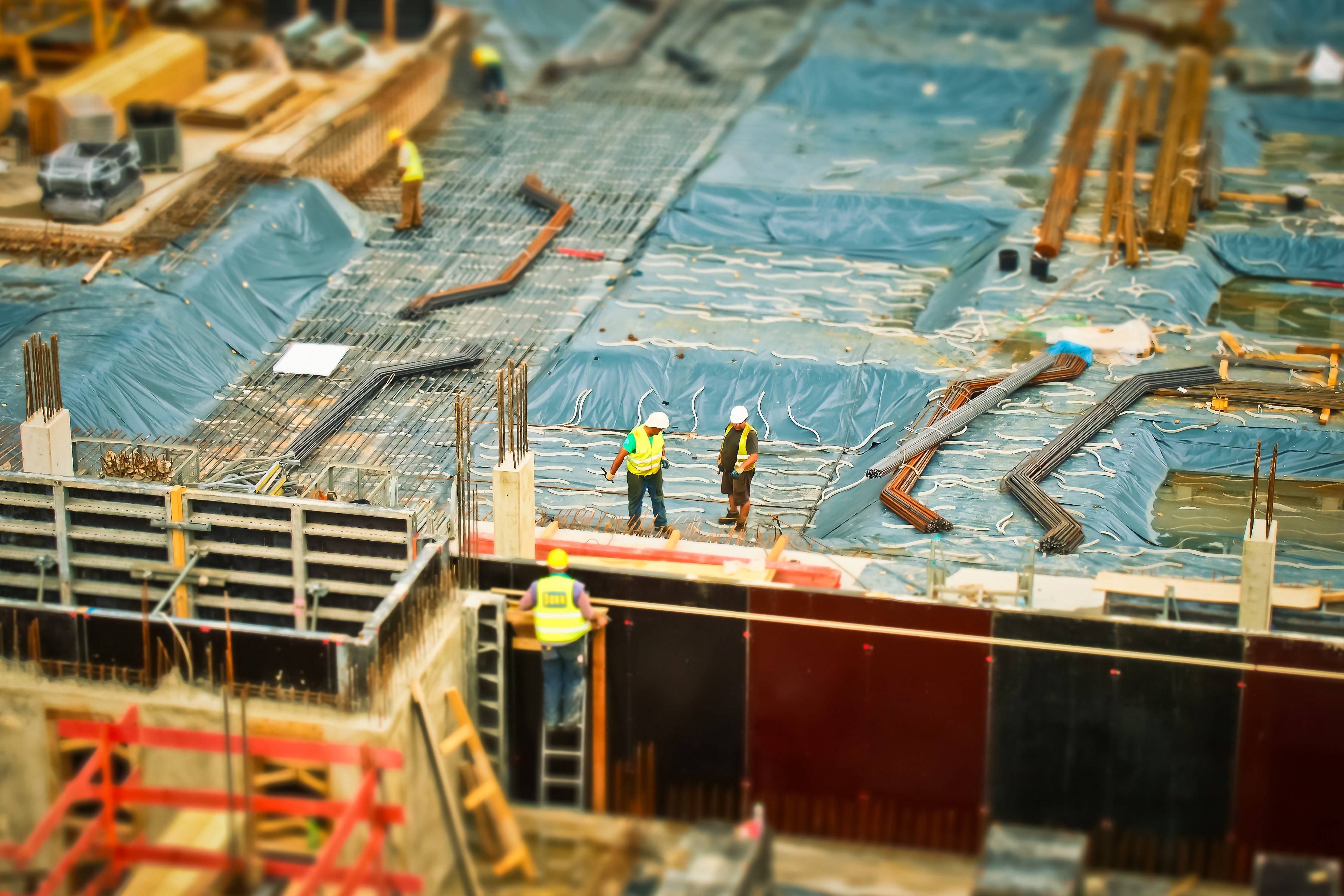 birds eye view of construction site and construction workers