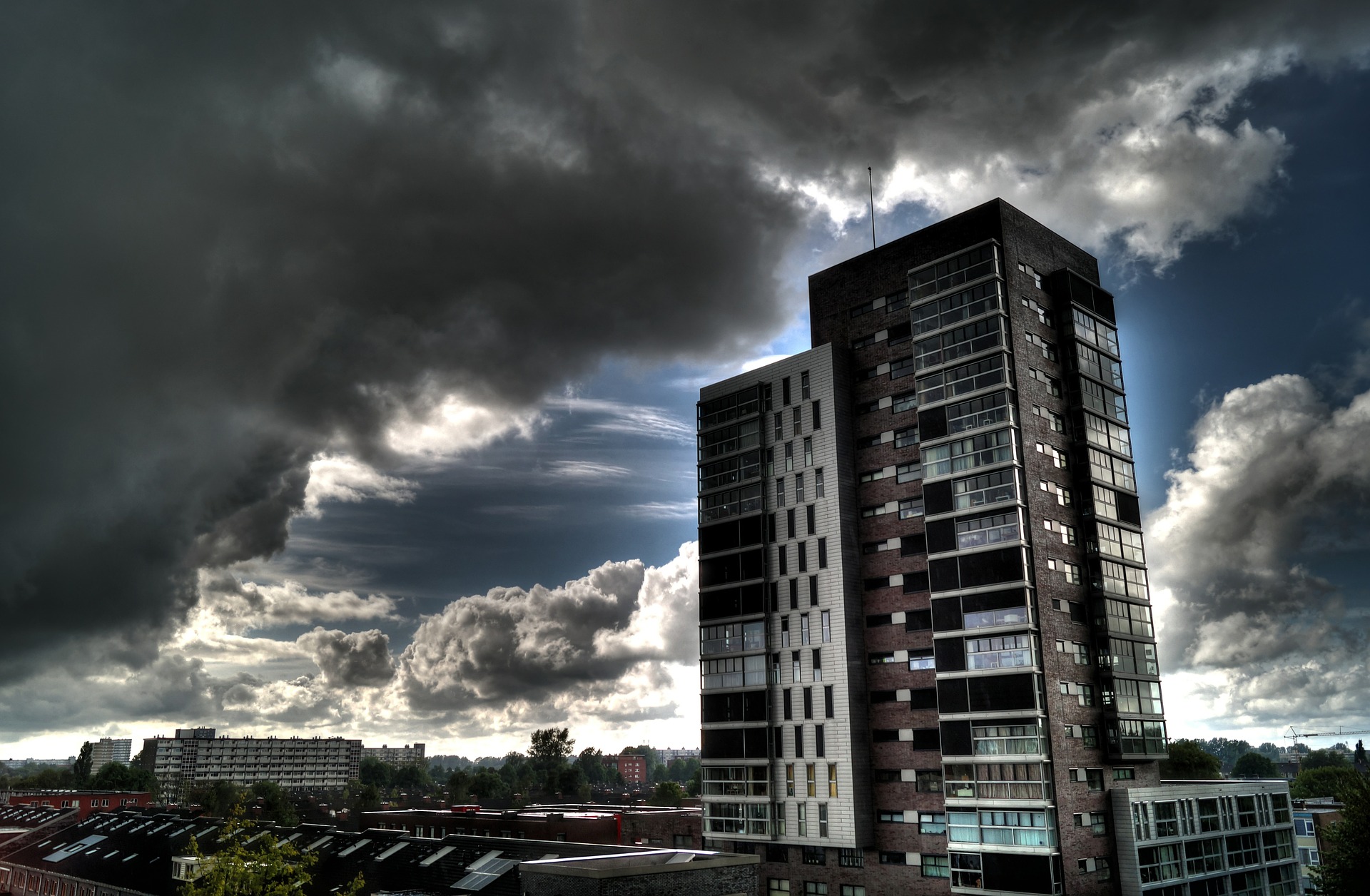 storm clouds and tall apartment building