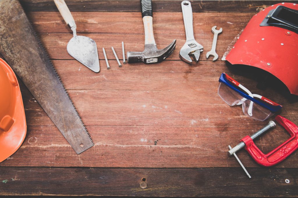 basic handyman tools on wooden table