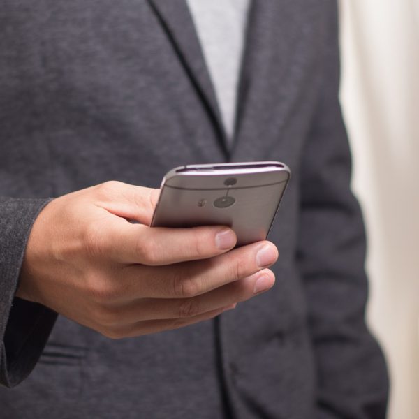 businessman holding his smartphone