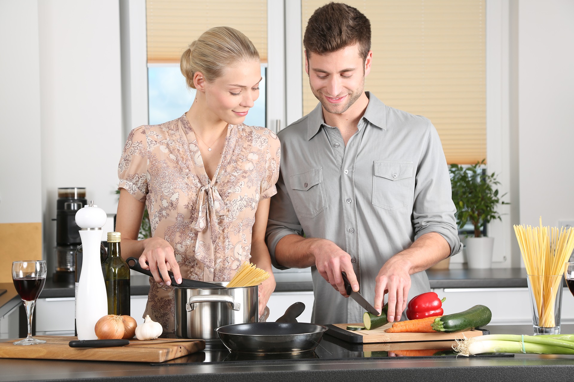 happy couple cooking dinner in kitchen together