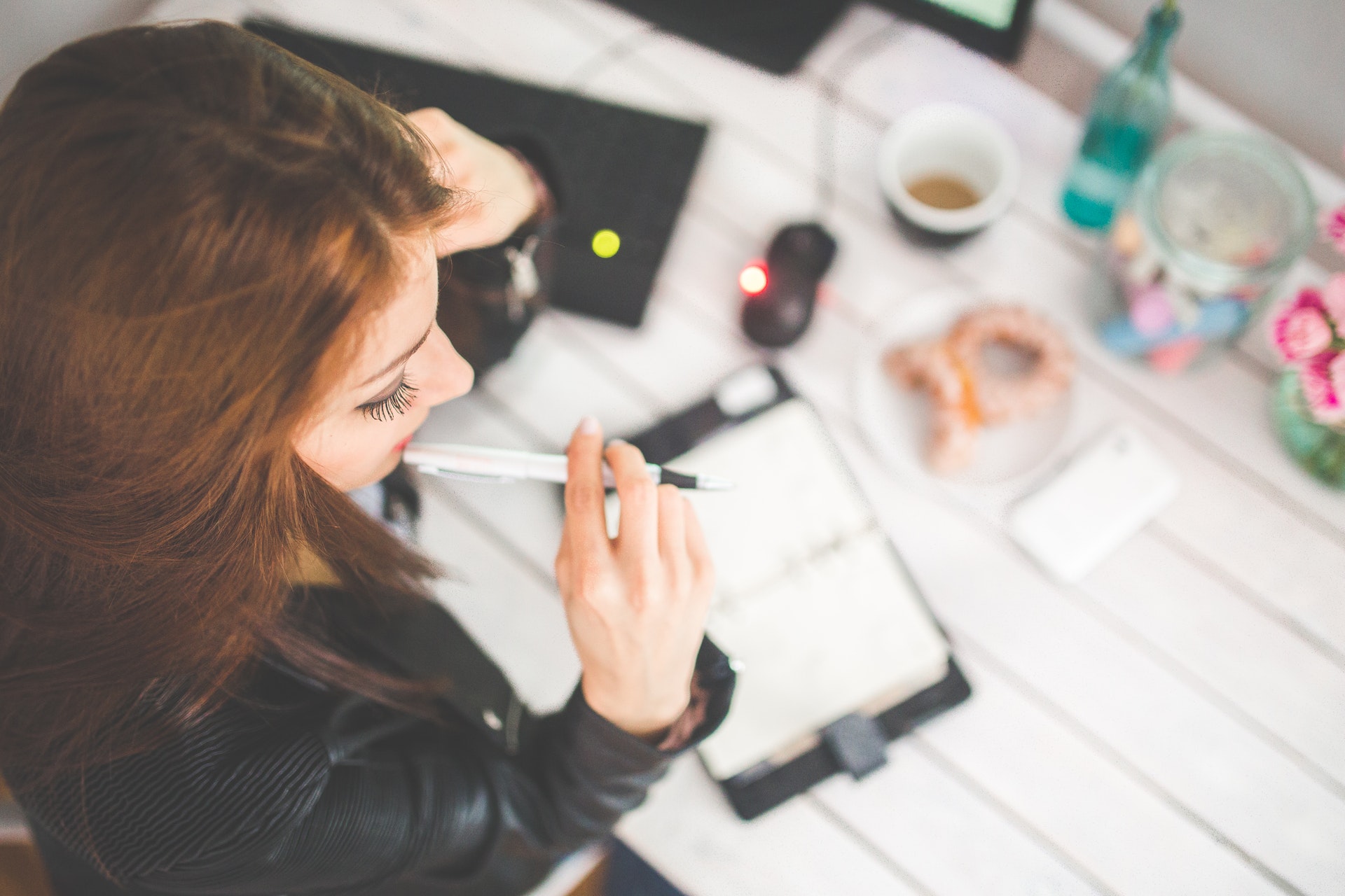 woman with pen in mouth contemplating her home renovation