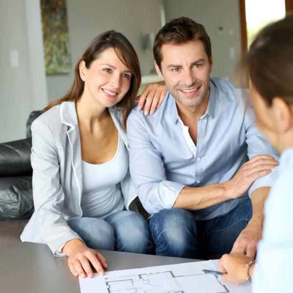 couple discussing their home renovation and insurance claim with potential contractor