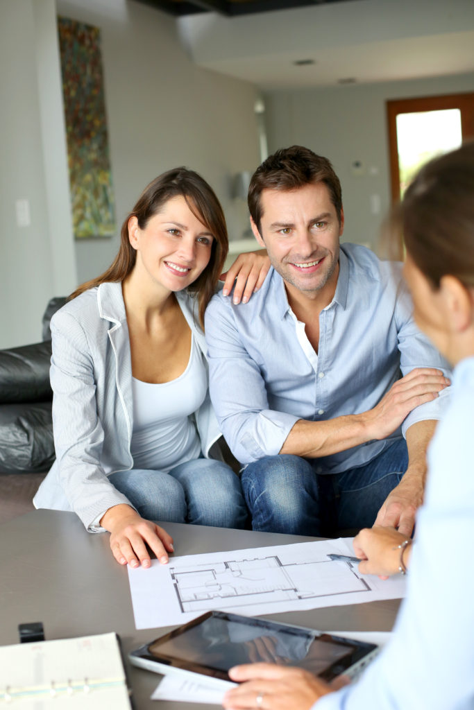 couple discussing their home renovation and insurance claim with potential contractor