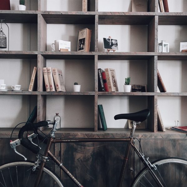 rustic wood built in bookshelf with bicycle in front of it