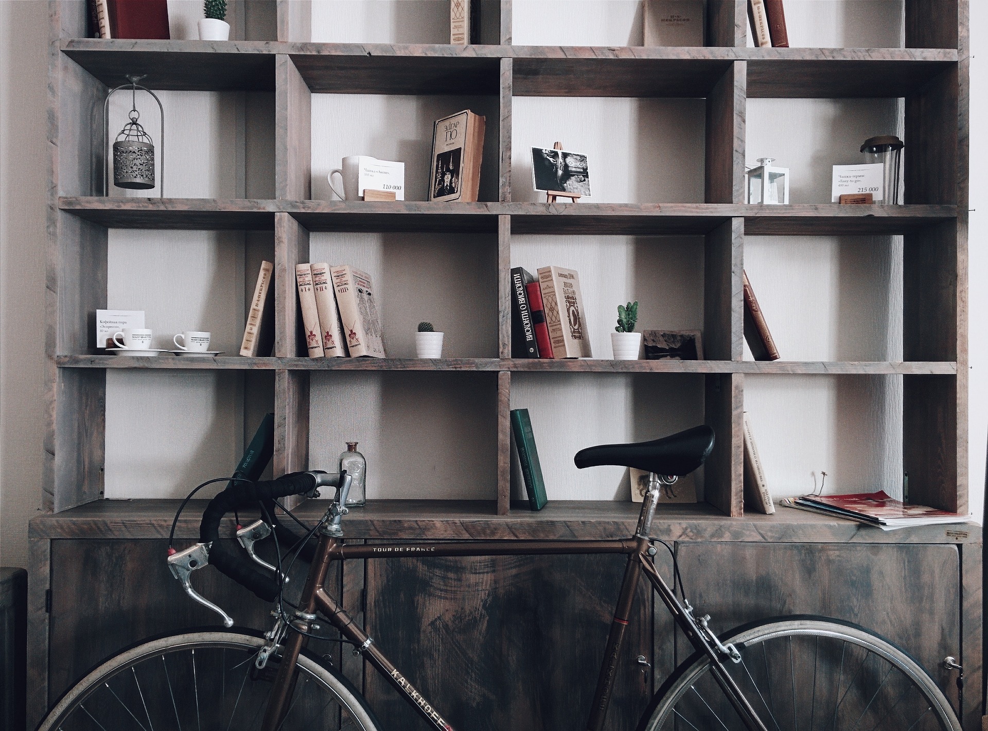 rustic wood built in bookshelf with bicycle in front of it