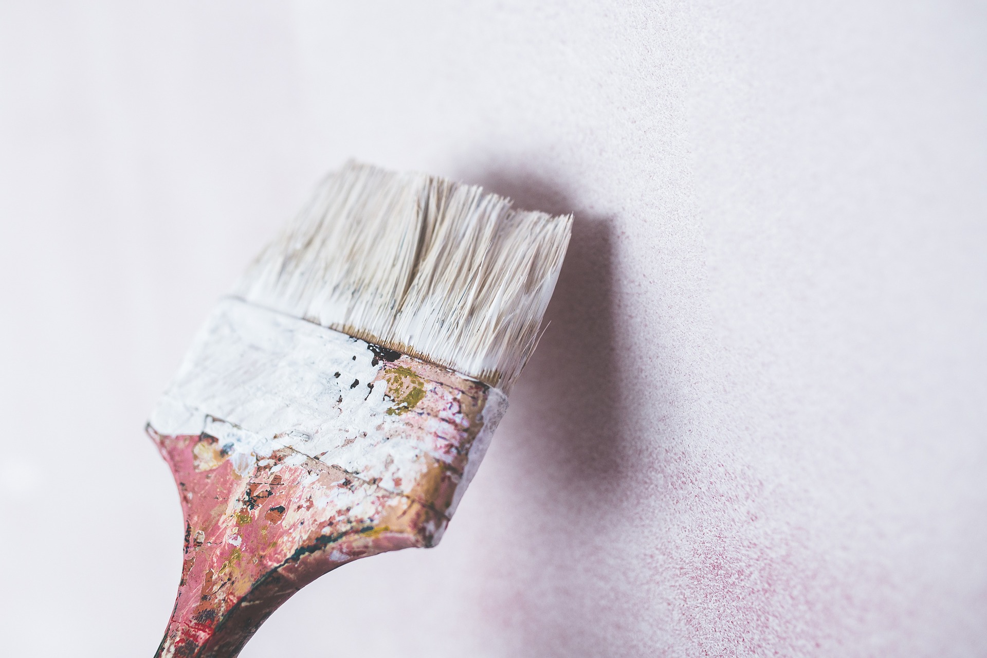 paintbrush covered in white paint