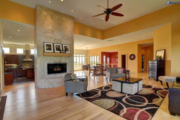Spacious living room with fireplace and hardwood floors.