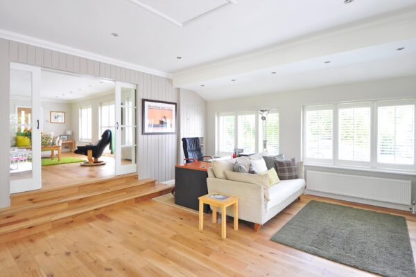 Modern living room with wooden floors and white walls.